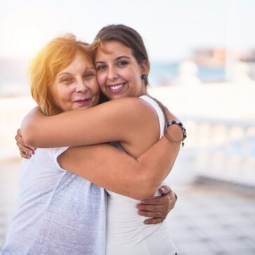 Two women hugging each other